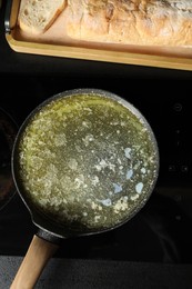 Photo of Melted butter in frying pan on cooktop, top view