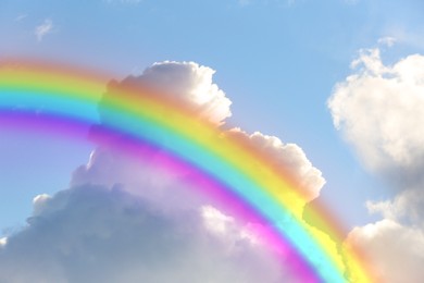 Image of Beautiful view of bright rainbow in blue sky on sunny day