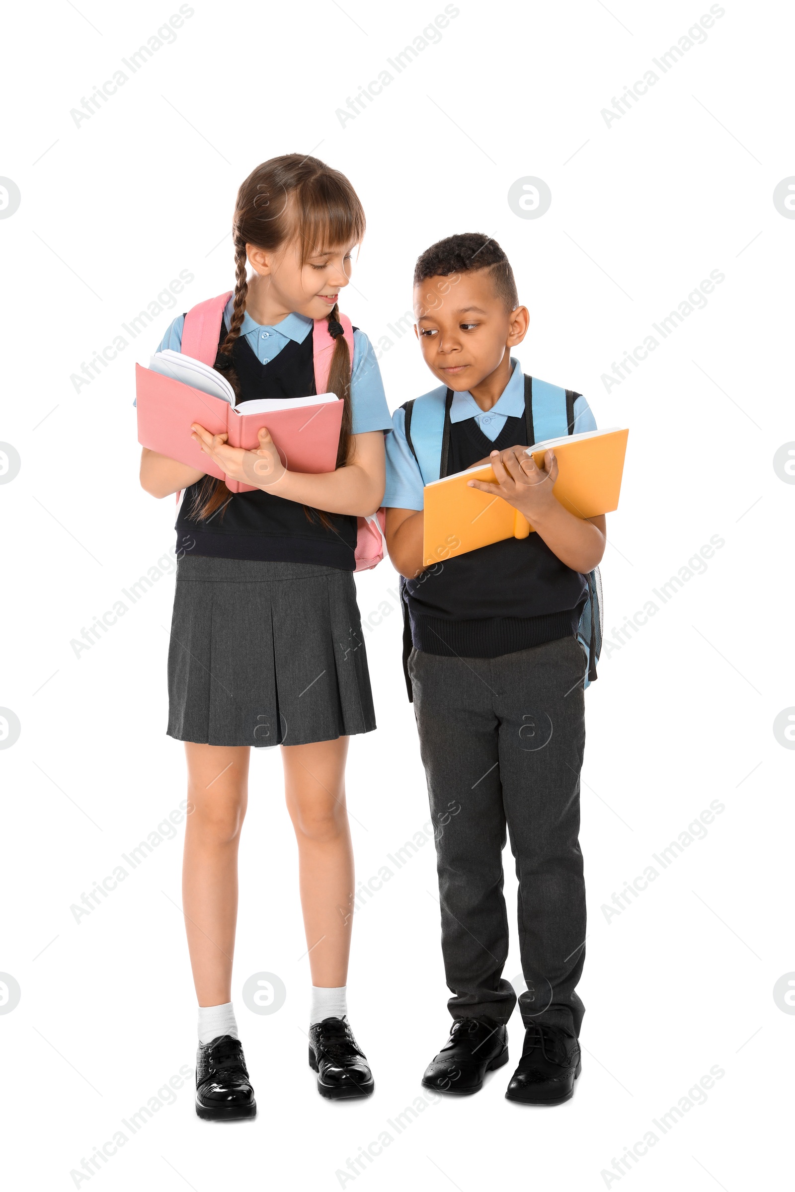 Photo of Full length portrait of cute children in school uniform on white background