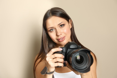 Photo of Professional photographer working on beige background in studio