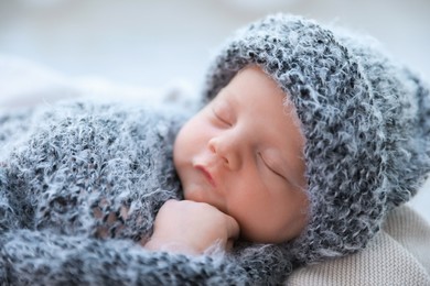 Photo of Cute newborn baby sleeping on plaid, closeup