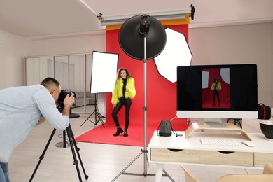 Photo of Beautiful African American model posing for professional photographer in studio