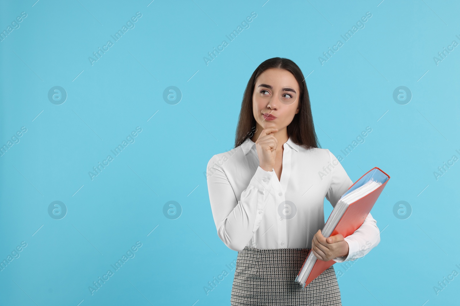 Photo of Curious woman with folder on light blue background, space for text