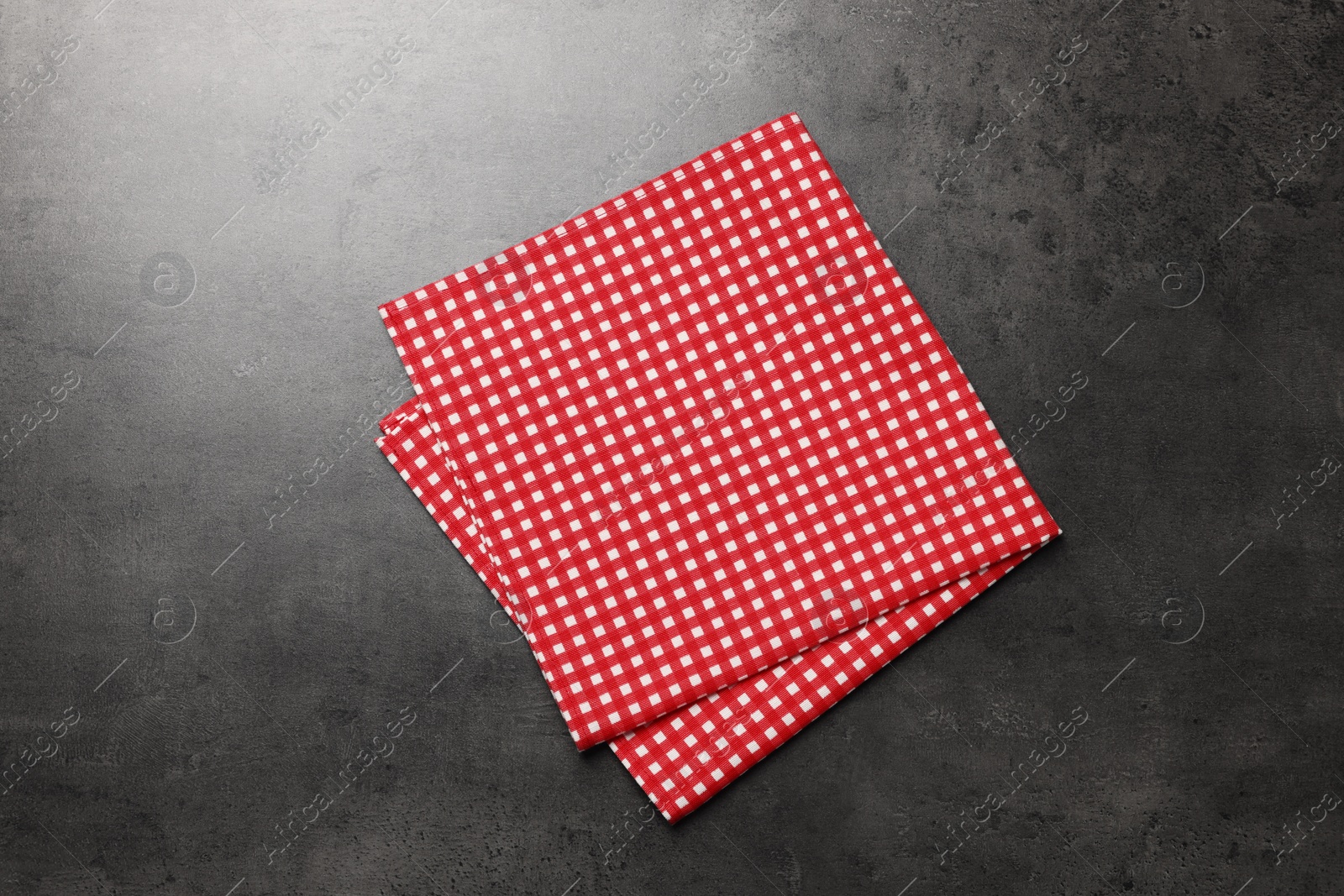 Photo of Checkered tablecloth on grey background, top view