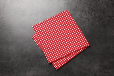 Checkered tablecloth on grey background, top view