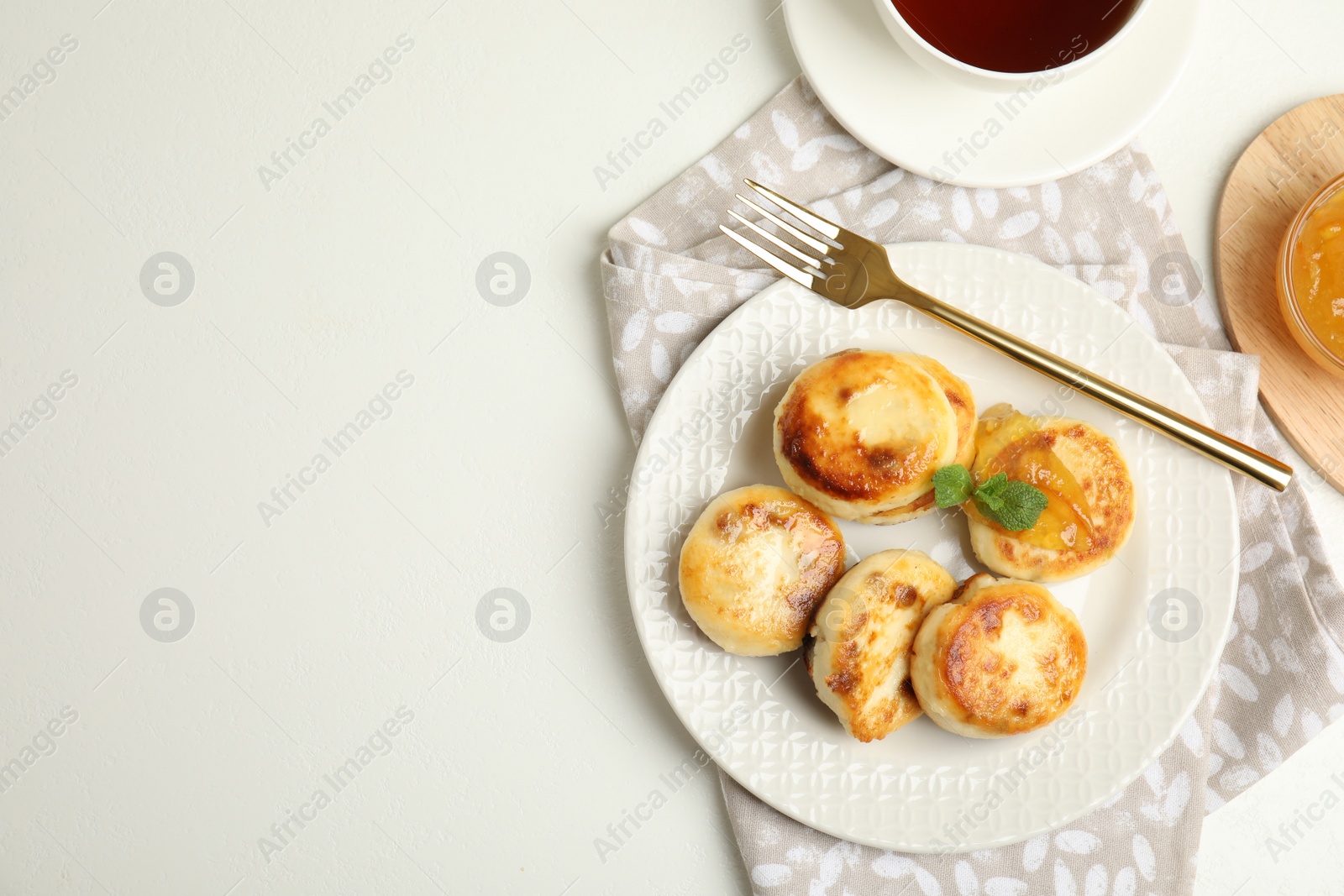 Photo of Delicious cottage cheese pancakes on white table, flat lay. Space for text