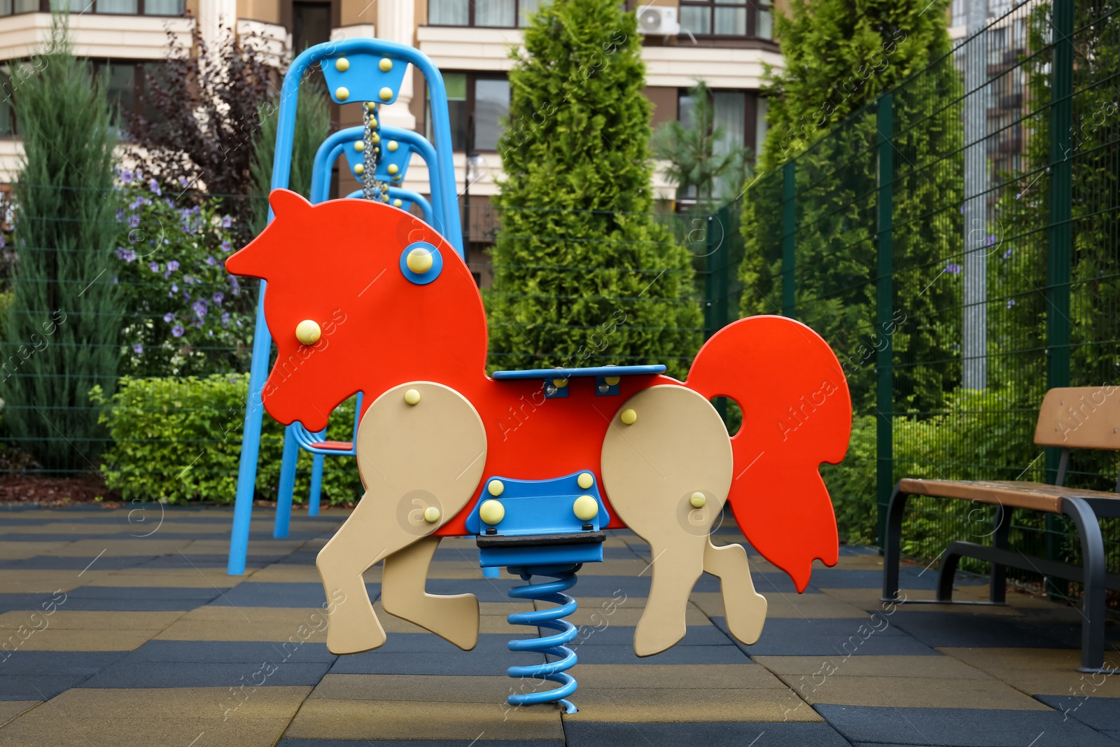 Photo of Empty horse spring rider on children's playground in residential area