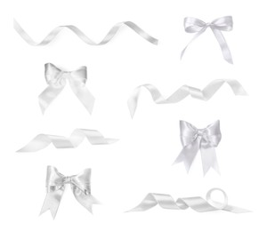 White satin ribbons and bows isolated on white, set