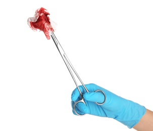 Photo of Doctor in medical glove holding clamp with tissue and blood on white background