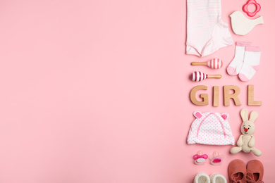 Photo of Flat lay composition with child's clothes and word Girl on pink background, space for text