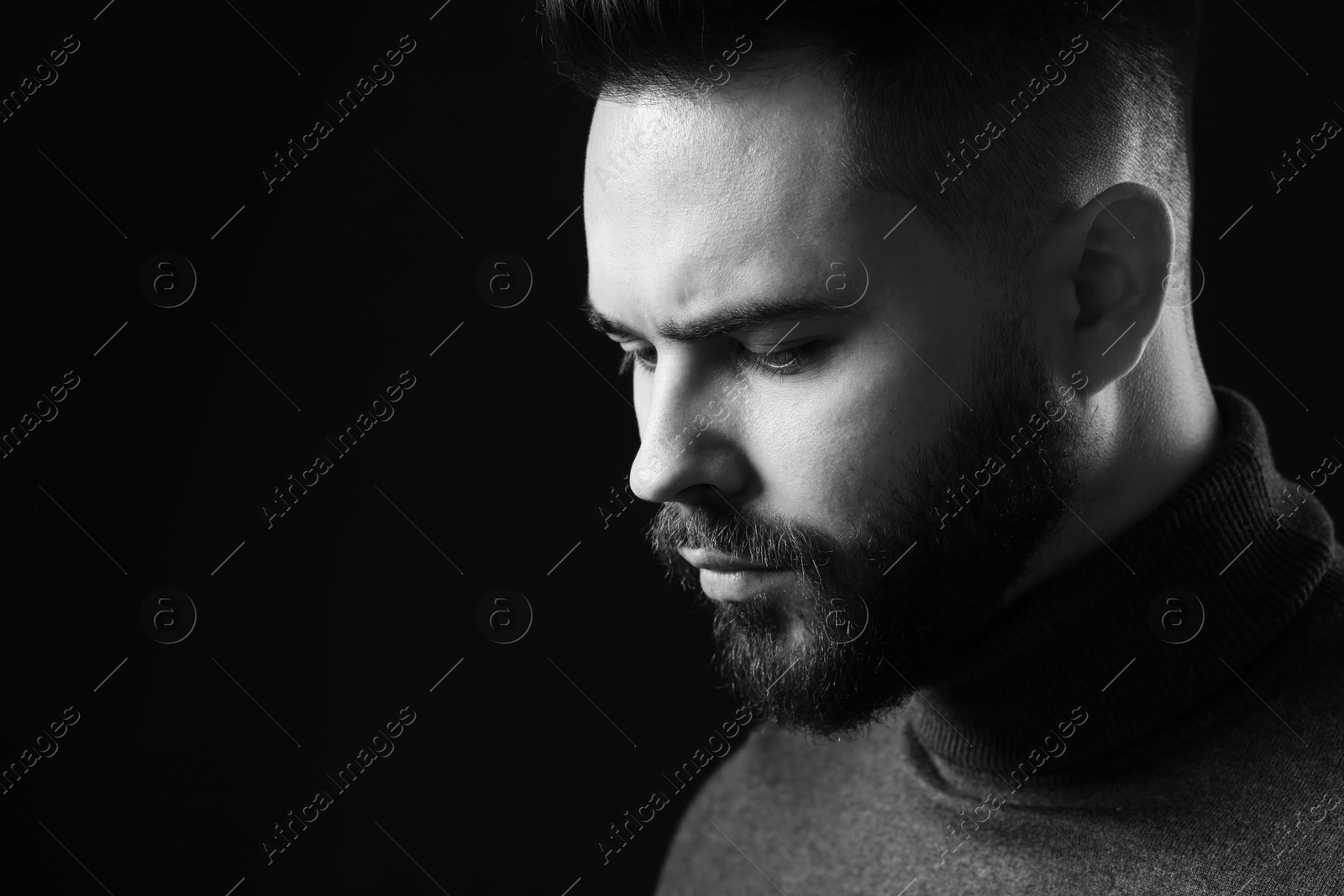 Photo of Portrait of handsome bearded man on dark background, space for text. Black and white effect