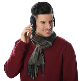 Photo of Man wearing stylish earmuffs and scarf on white background