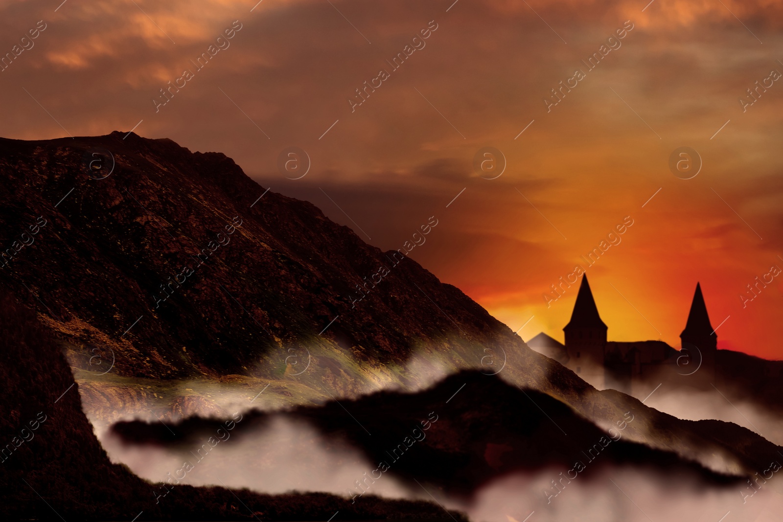 Image of Fantasy world. Mystical castle and mountains covering with fog in night