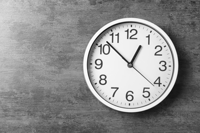 Photo of Modern clock on grey background, top view. Time management