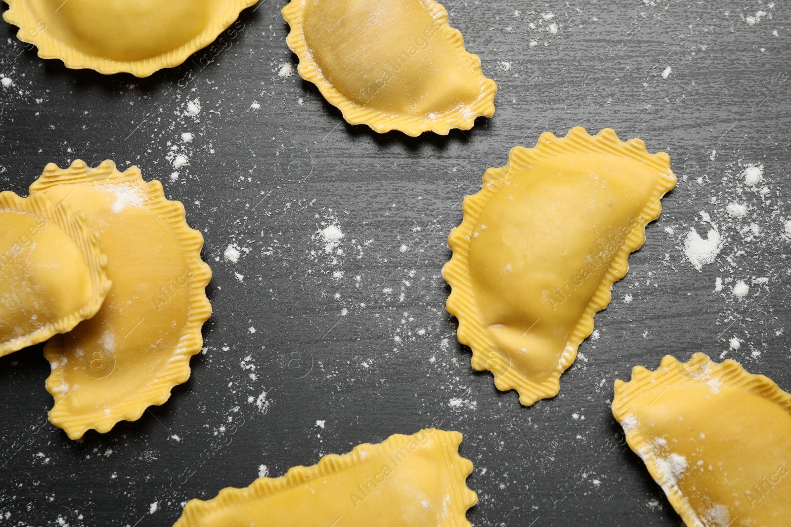 Photo of Ravioli on grey wooden table, flat lay. Italian pasta