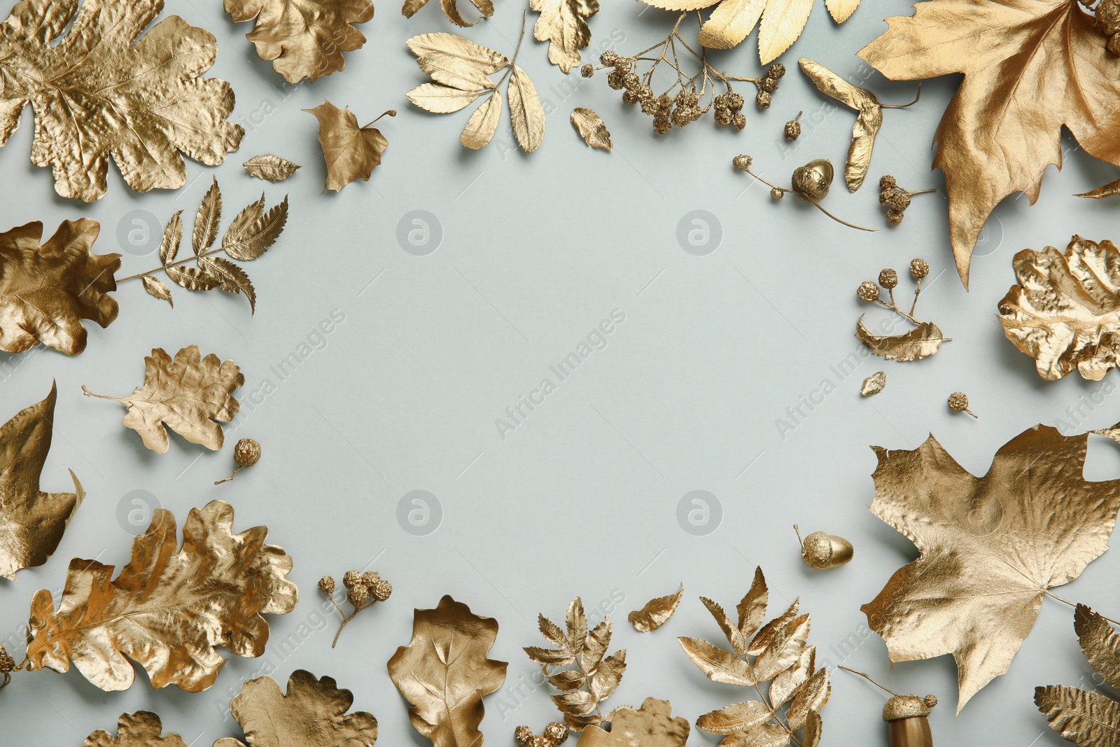 Photo of Frame made of different golden leaves on light grey background, flat lay with space for text. Autumn decor