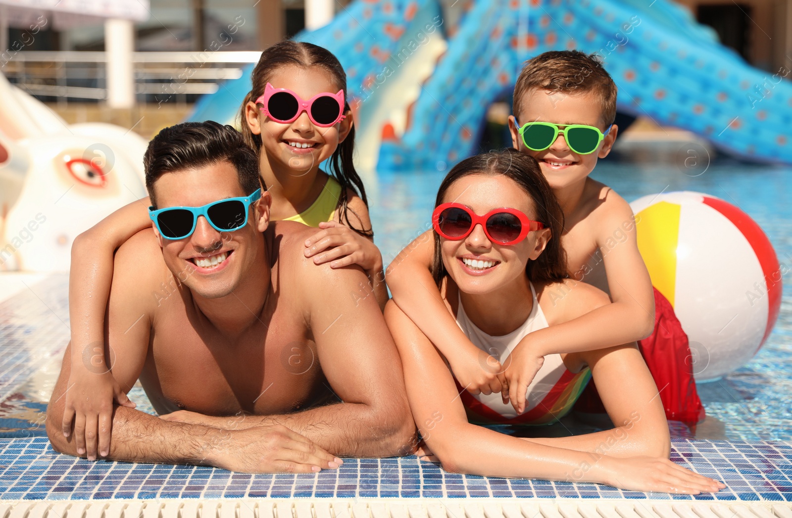 Photo of Happy family in swimming pool. Summer vacation