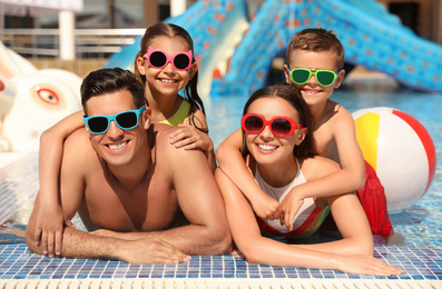 Photo of Happy family in swimming pool. Summer vacation