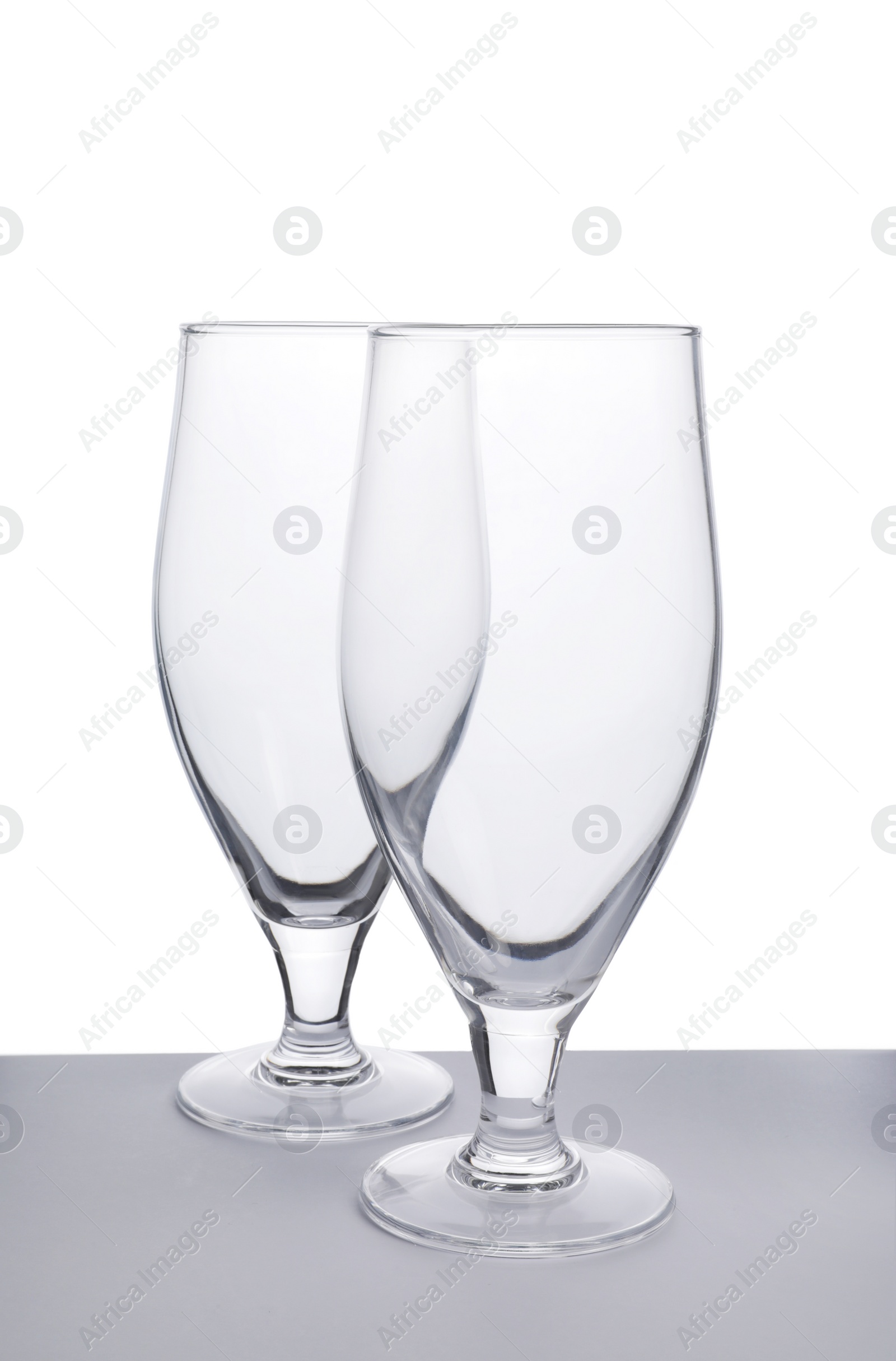 Photo of Elegant clean empty cocktail glasses isolated on white