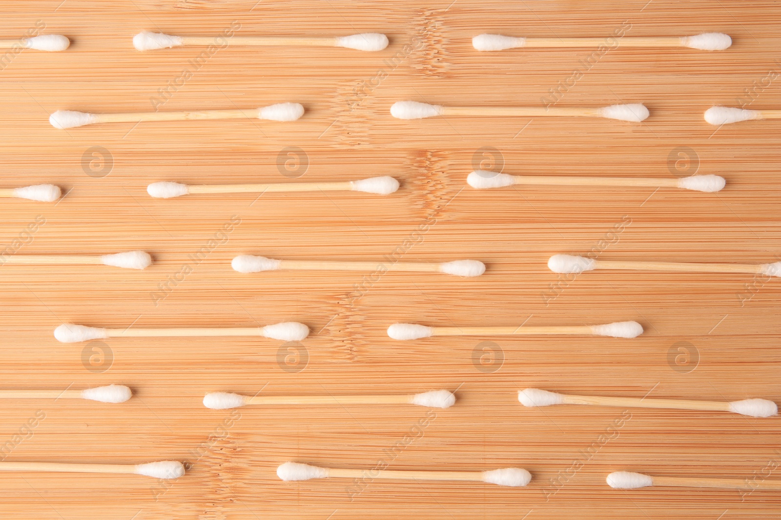 Photo of Many clean cotton buds on wooden table, flat lay