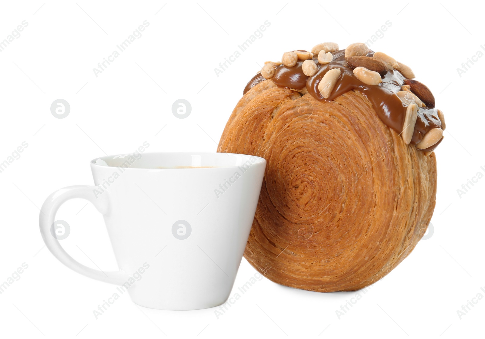 Photo of Round croissant with chocolate paste, nuts and cup of drink isolated on white. Tasty puff pastry