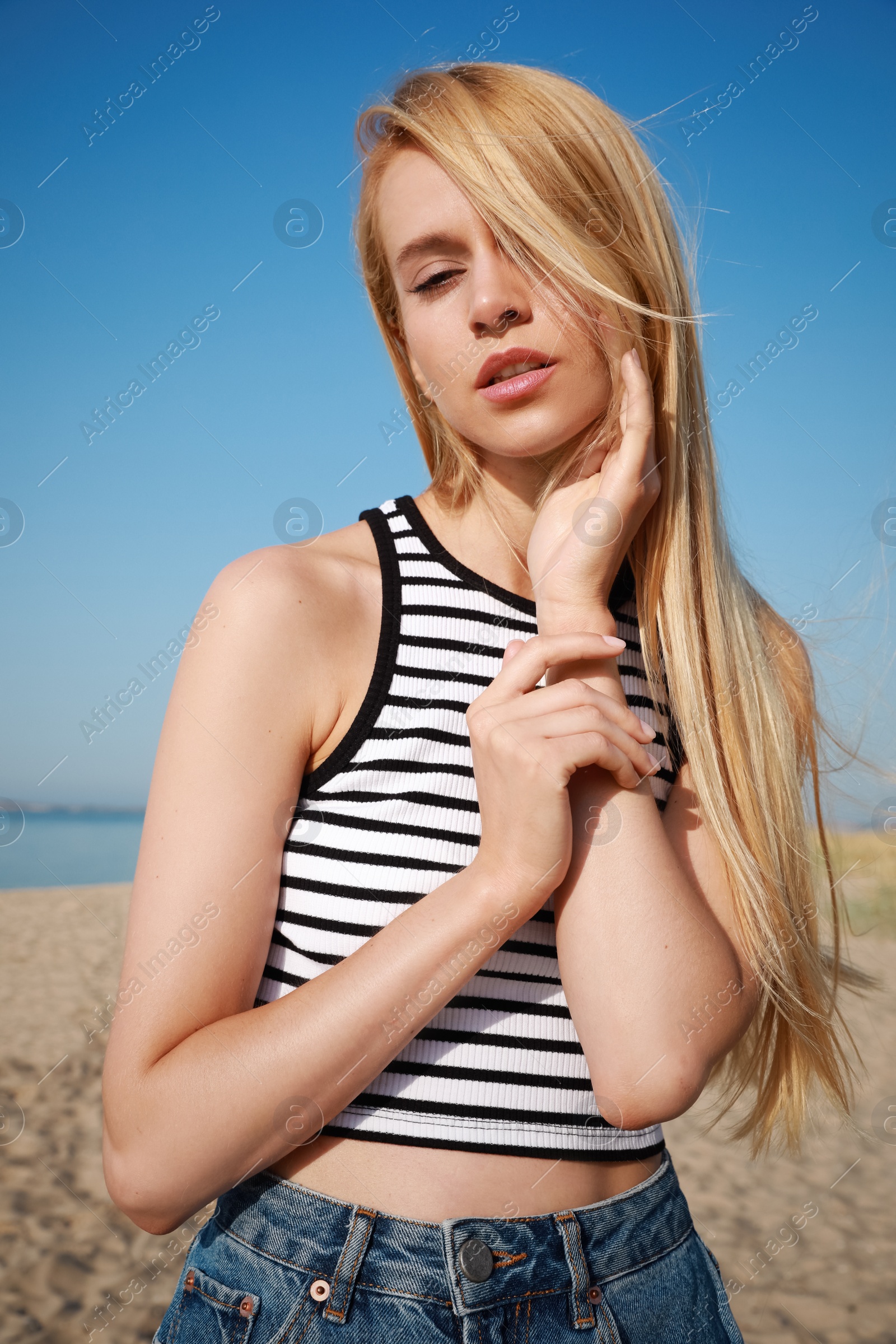 Photo of Beautiful young woman near sea on sunny day in summer