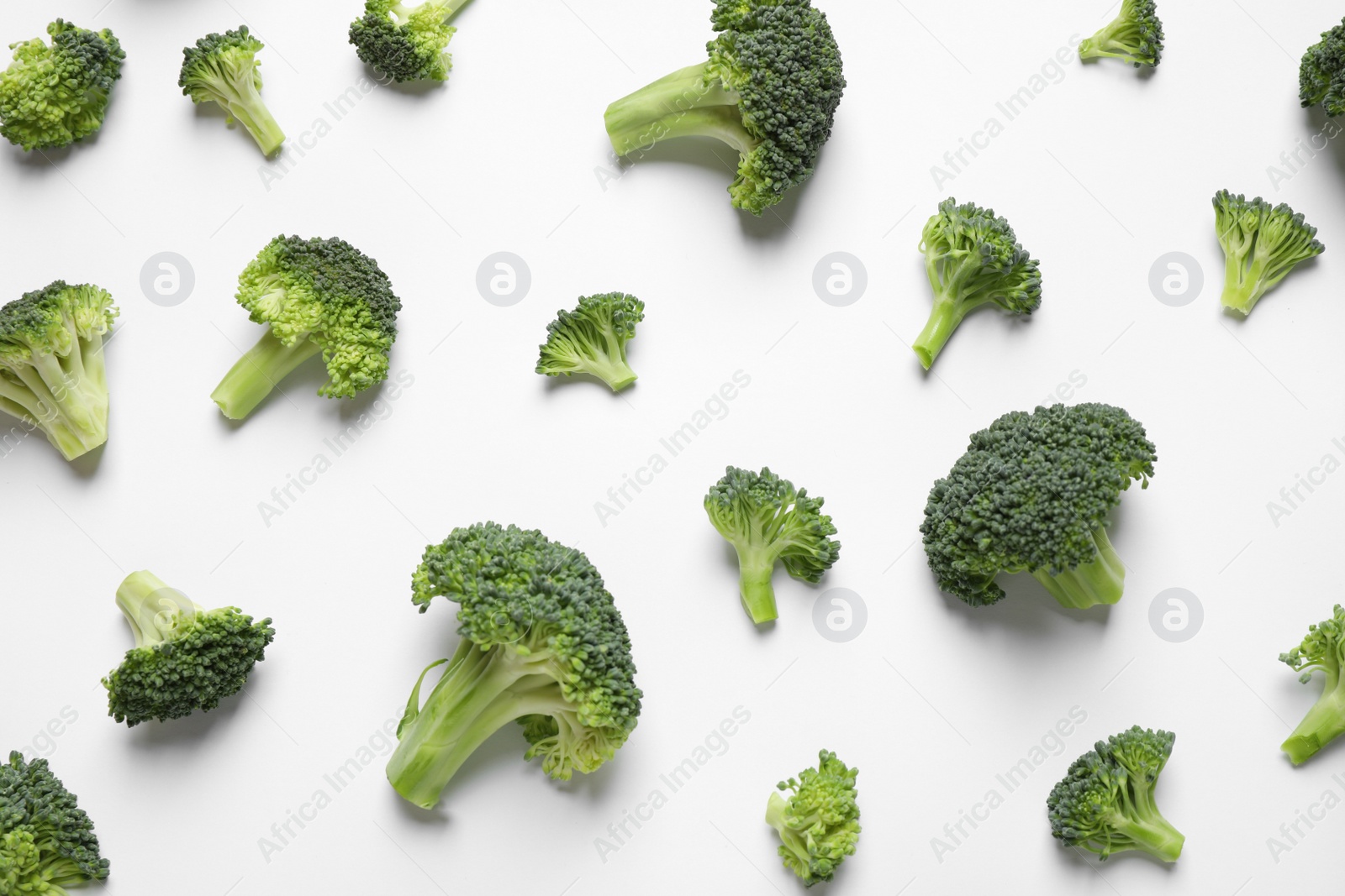 Photo of Fresh tasty broccoli on white background, top view