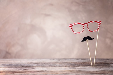 Photo of Paper glasses and moustache on color background. Father's day celebration