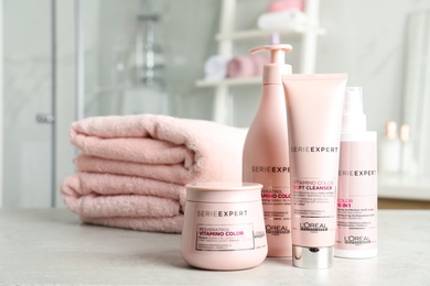 MYKOLAIV, UKRAINE - AUGUST 08, 2020: Set of L'Oreal hair care cosmetic products on light grey stone table in bathroom