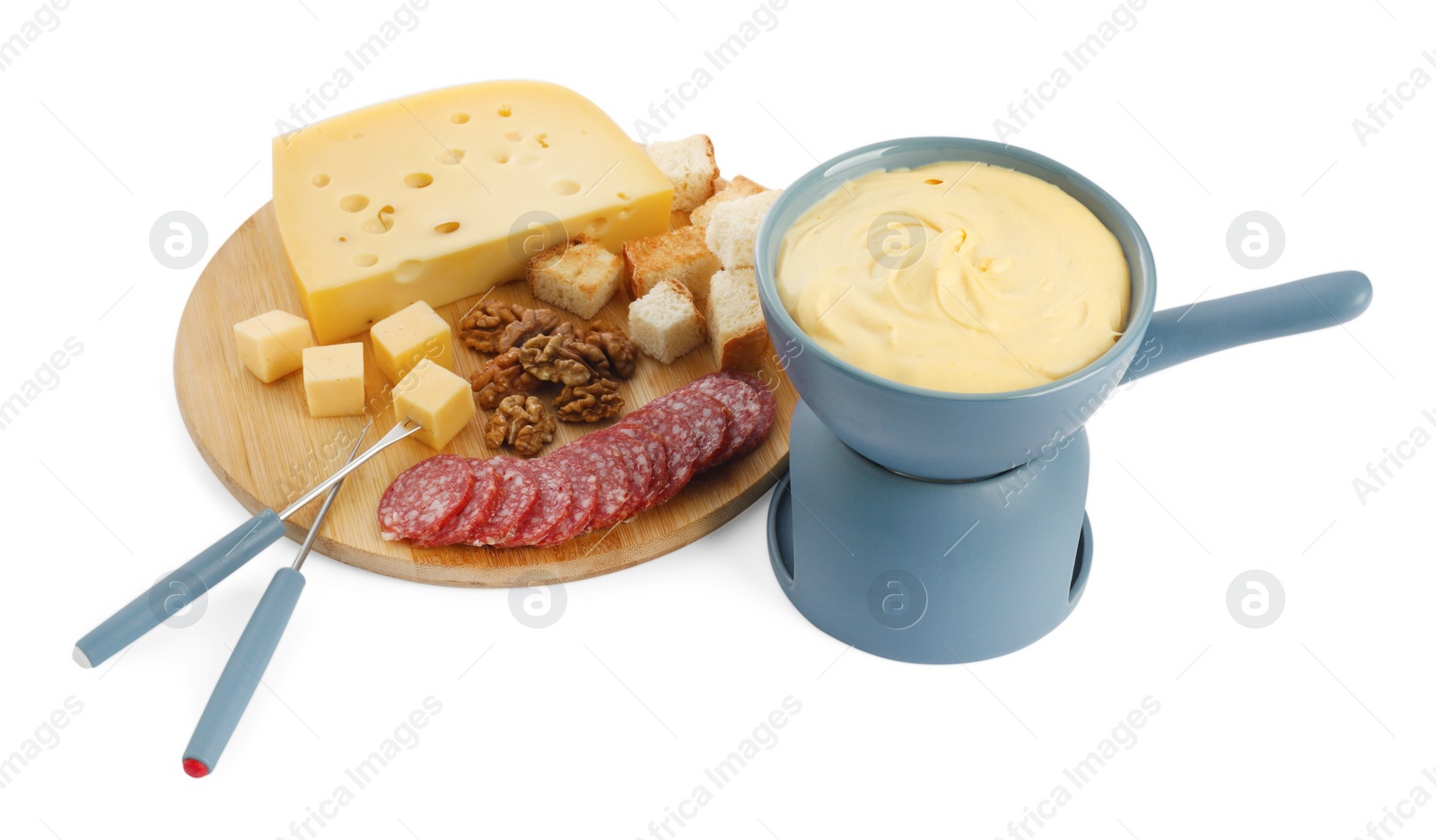 Photo of Fondue with tasty melted cheese, forks and different snacks isolated on white