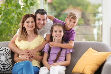 Photo of Happy family with cute children at home