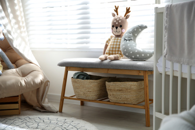 Bench with toys near window in baby room. Interior design