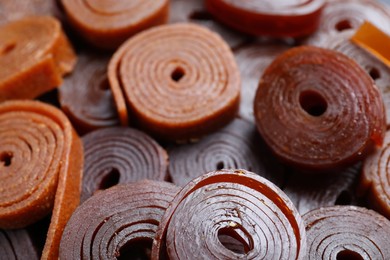 Photo of Delicious fruit leather rolls as background, closeup