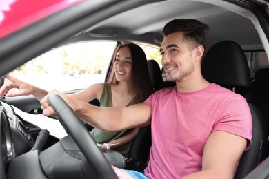 Photo of Young couple with map in car on road trip