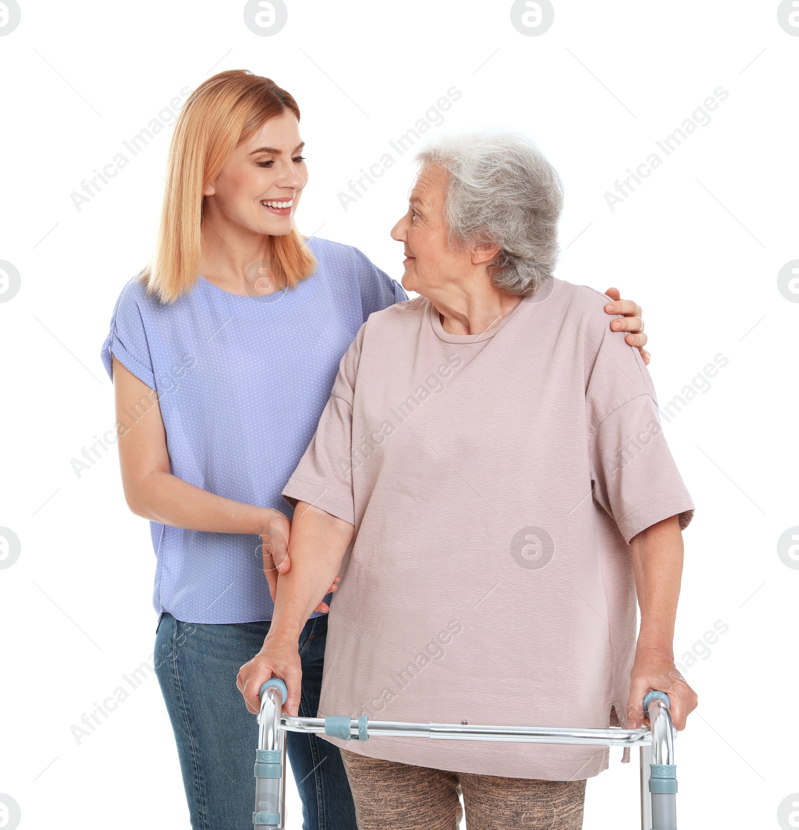 Photo of Caretaker helping elderly woman with walking frame on white background