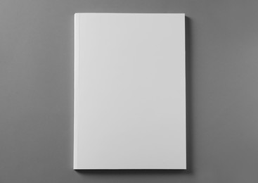 Brochure with blank cover on light grey background, top view