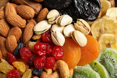 Different dried fruits and nuts as background, closeup