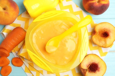 Photo of Baby food in bowl and fresh ingredients on table, flat lay