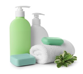 Photo of Soap bars, dispensers and terry towel on white background
