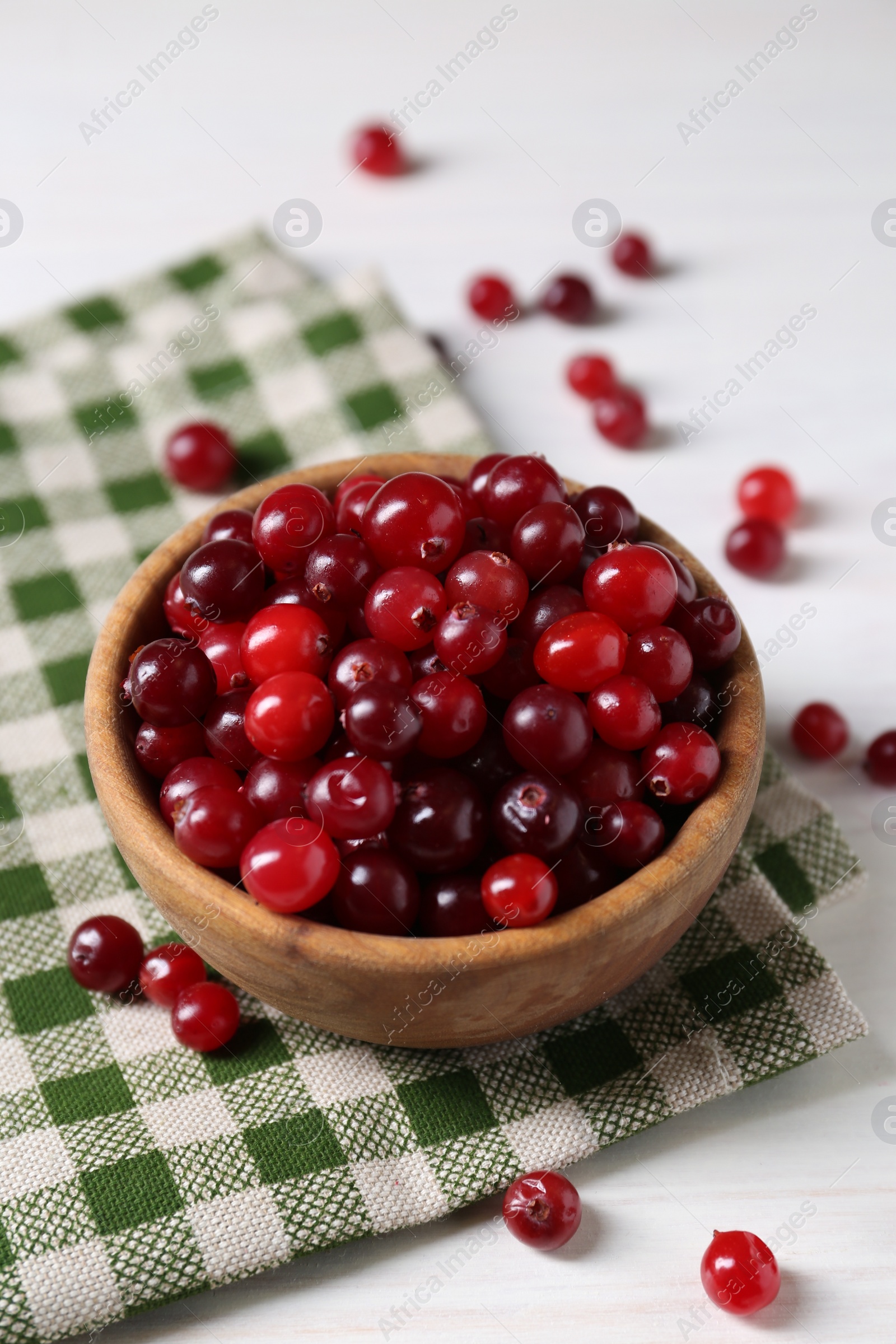 Photo of Fresh ripe cranberries in bowl on white table