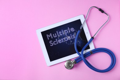 Multiple Sclerosis concept. Flat lay composition with tablet and stethoscope on pink background