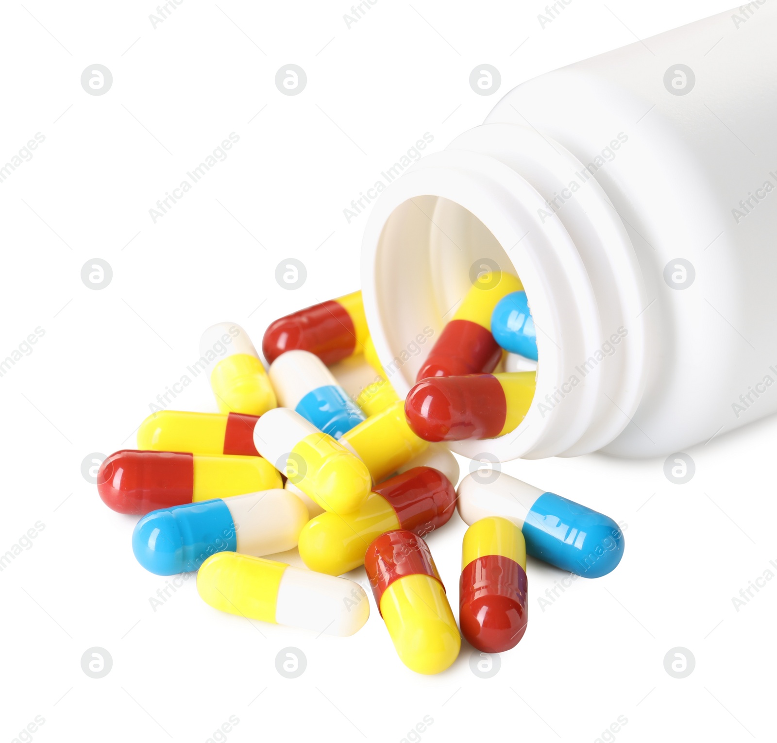 Photo of Scattered antibiotic pills and bottle isolated on white