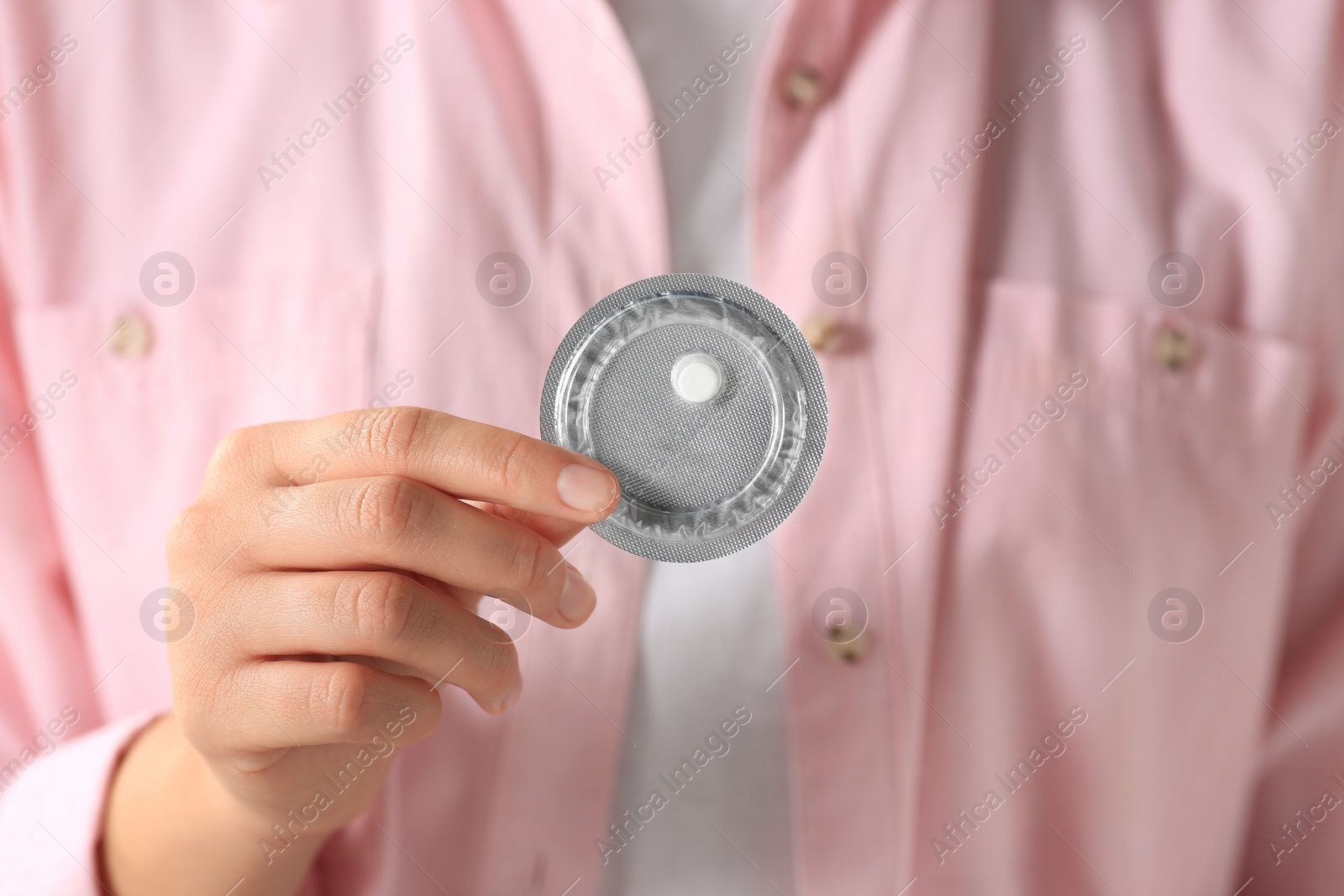 Photo of Woman holding blister of emergency contraception pill, focus on hand