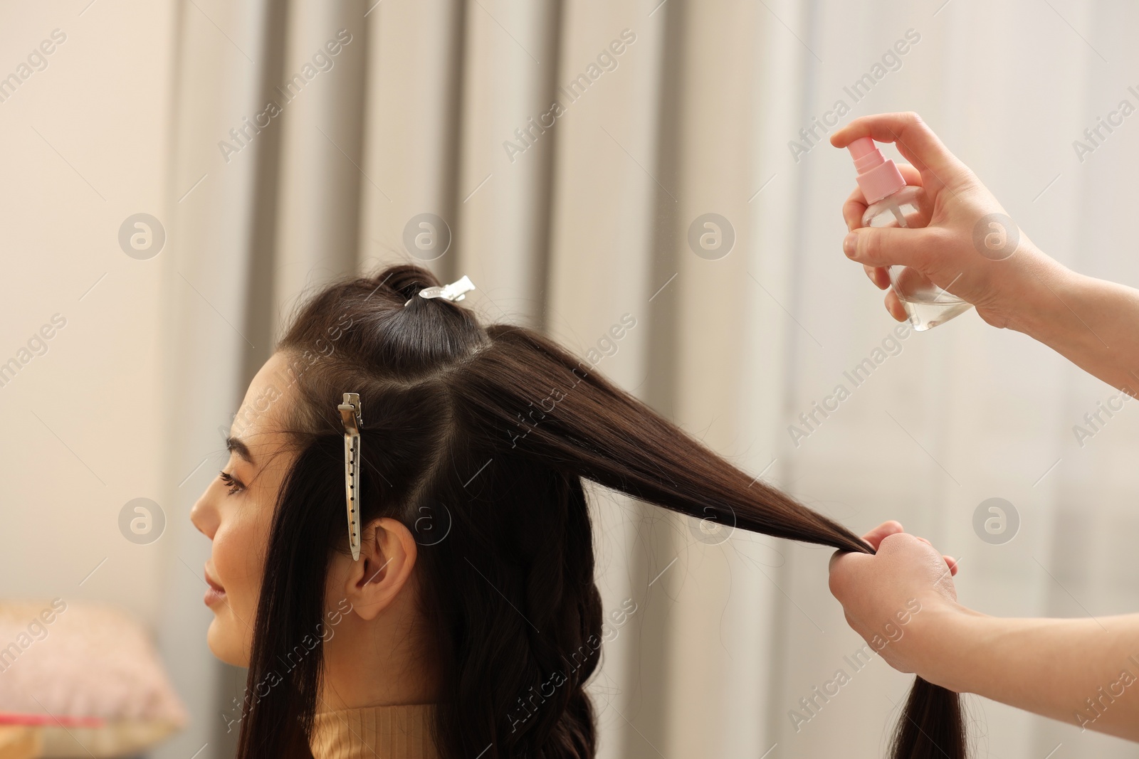 Photo of Hair styling. Professional hairdresser working with client in salon, closeup