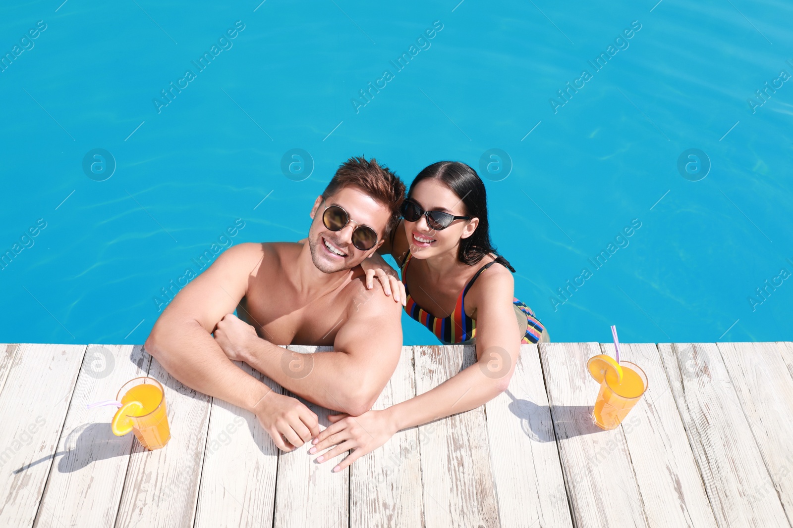 Photo of Woman in bikini with boyfriend at resort. Happy young couple