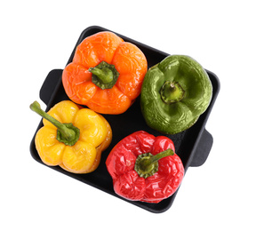 Photo of Tasty stuffed bell peppers in baking pan isolated on white, top view