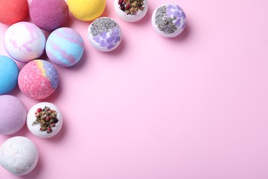 Photo of Colorful bath bombs on pink background, flat lay. Space for text