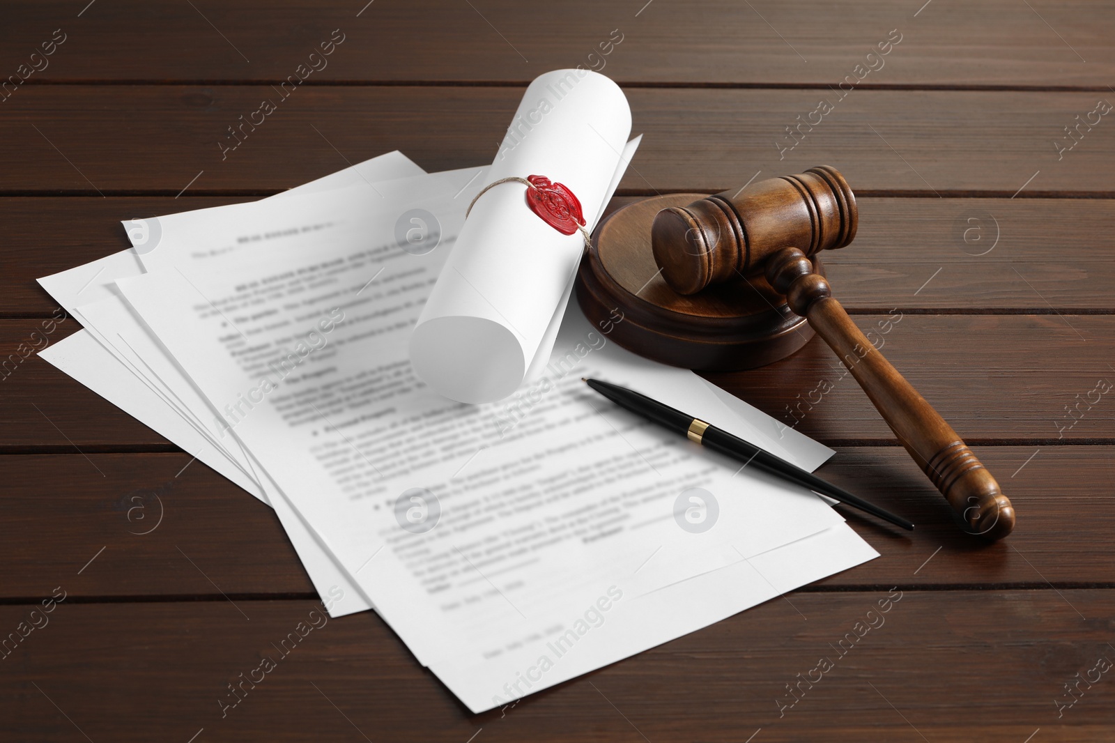 Photo of Notary contract. Documents, gavel and pen on wooden table