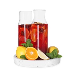 Photo of Jugs with tasty punch drink and ingredients isolated on white