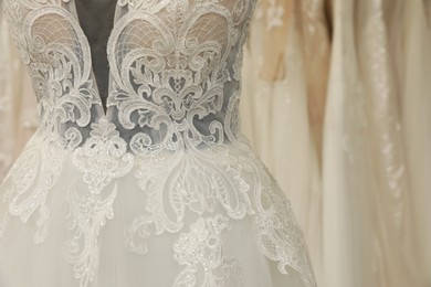 Beautiful wedding dress on mannequin in boutique, closeup